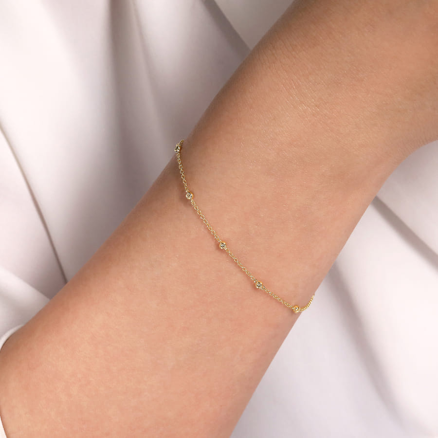 14 KARAT YELLOW GOLD DIAMOND STATIONS CHAIN BRACELET