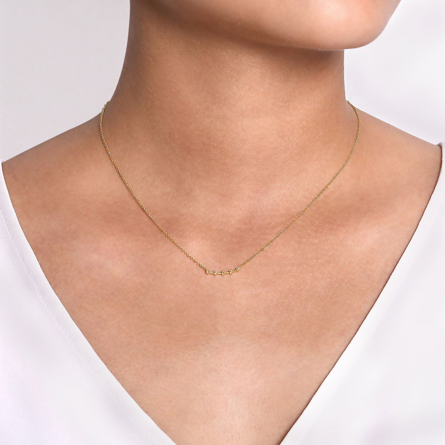 14 KARAT YELLOW GOLD DIAMOND STATIONS CURVED BAR NECKLACE