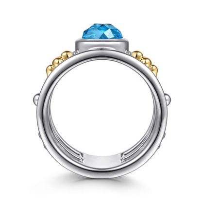 14 KARAT YELLOW GOLD AND STERLING SILVER BUJUKAN BLUE TOPAZ WIDE BAND RING