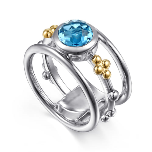 14 KARAT YELLOW GOLD AND STERLING SILVER BUJUKAN BLUE TOPAZ WIDE BAND RING