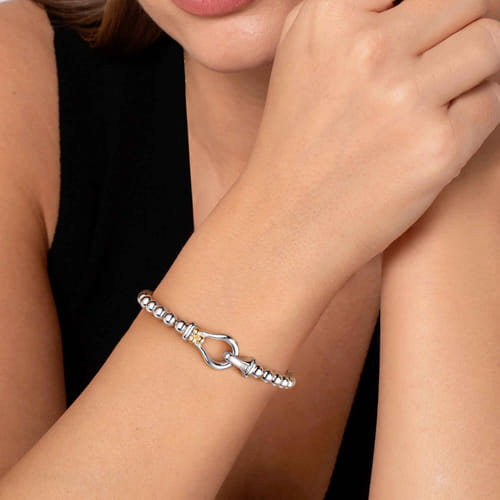 14 KARAT YELLOW GOLD AND STERLING SILVER BUJUKAN HORSE SHOE BANGLE BRACELET