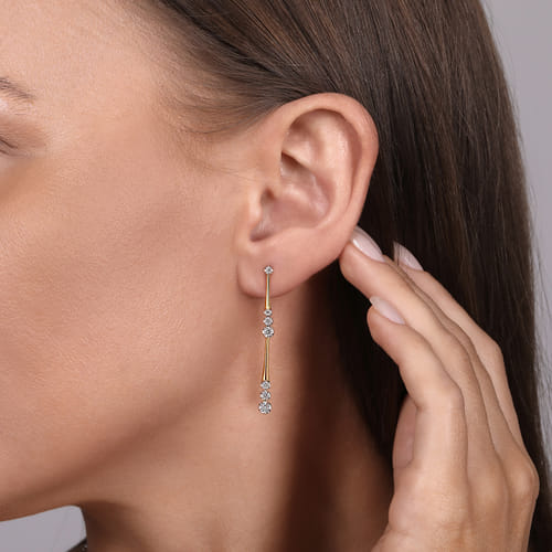 14 KARAT YELLOW GOLD LINEAR GRADUATED DIAMOND STATION DROP EARRINGS IN SIZE 45MM