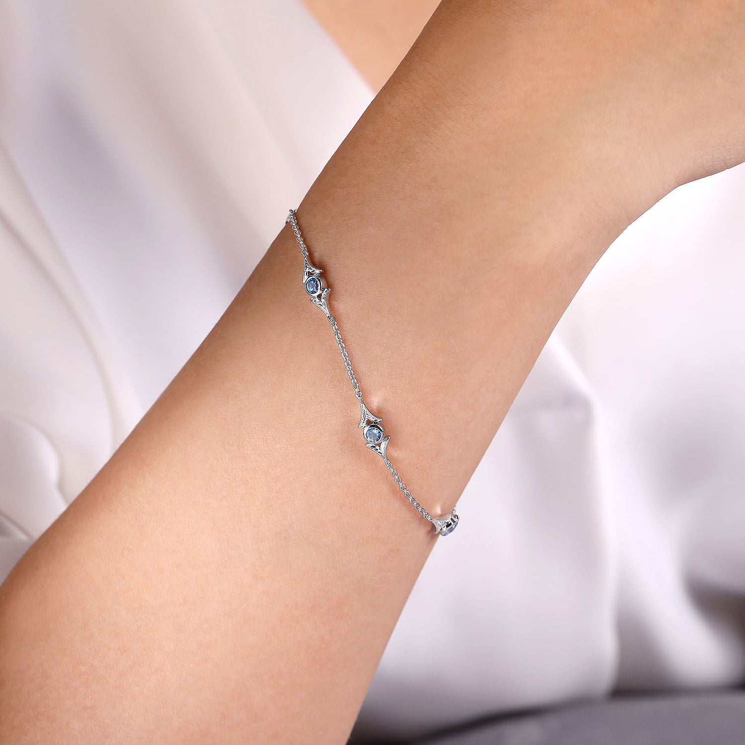 STERLING SILVER SWISS BLUE TOPAZ STATION BRACELET